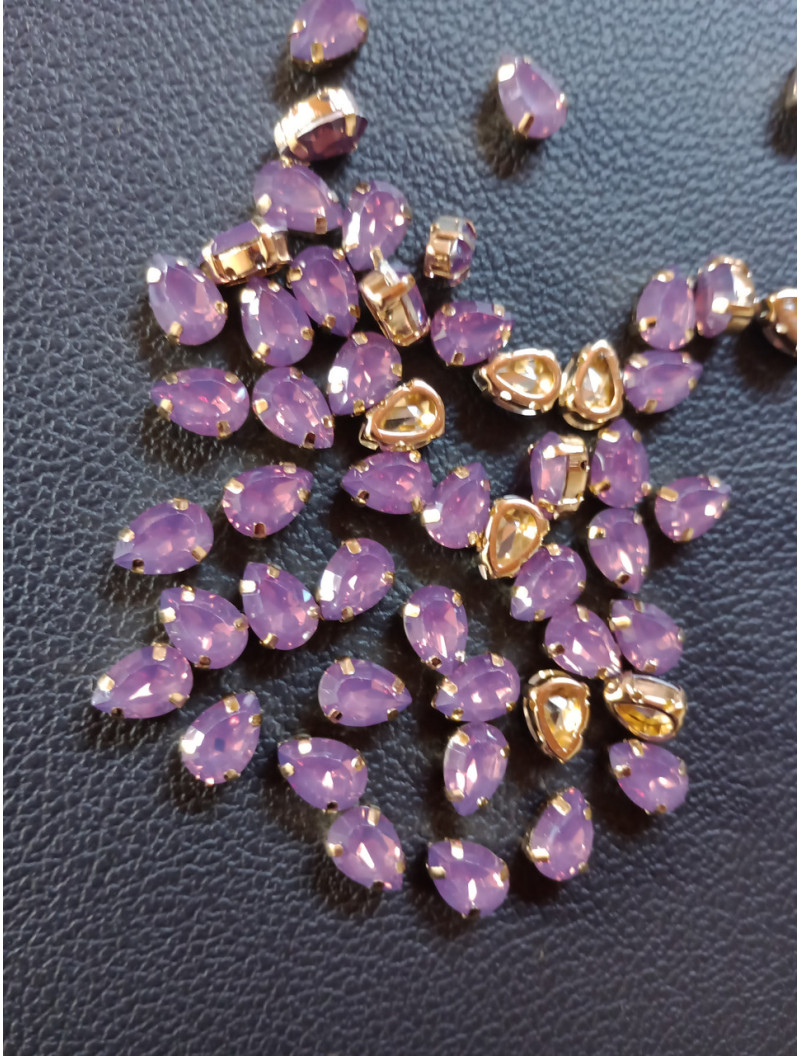 Стразі (акрил) у золотій металевій оправі. Розмір  6*10 мм. Колір  бузок світлий опал